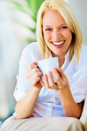 Woman holding a cup and smiling